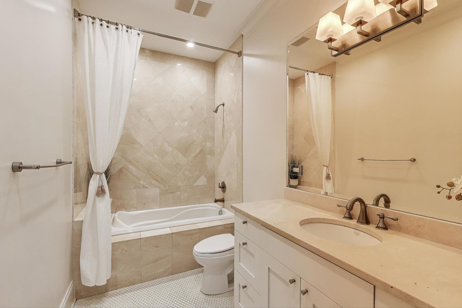 1758 West Surf Street Chicago, IL 60657 - Photo 29 of 51 a bathroom with a granite countertop sink a toilet and shower