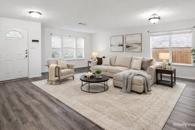 a living room with furniture and a large window