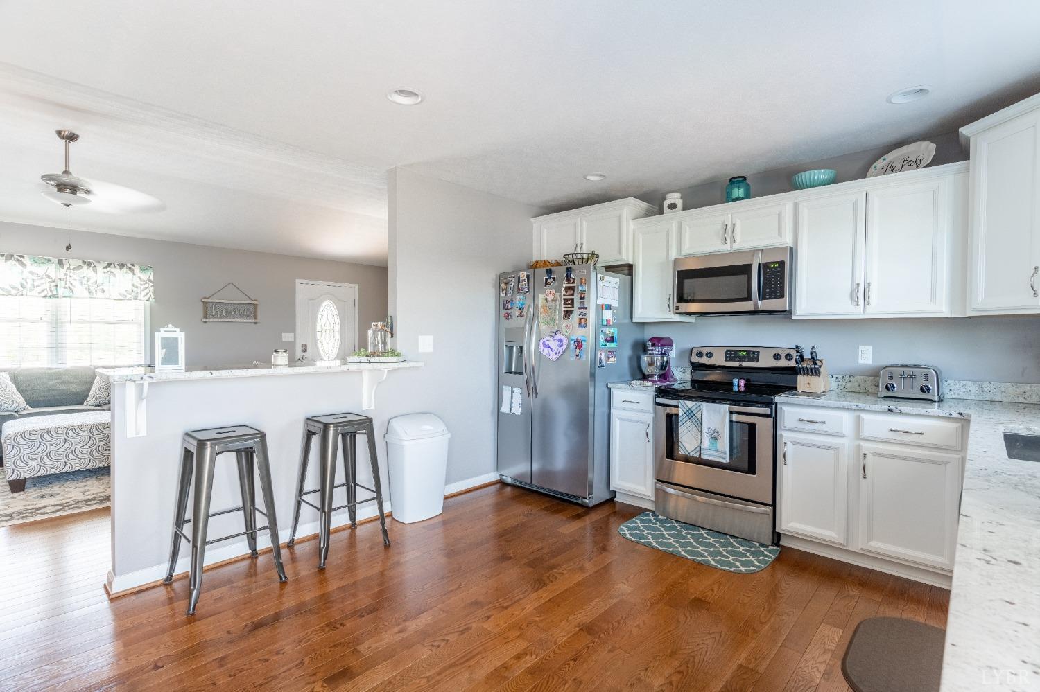 517 Beeks Lane Spout Spring, VA 24593 - Photo 7 of 33 a kitchen with white cabinets and stainless steel appliances