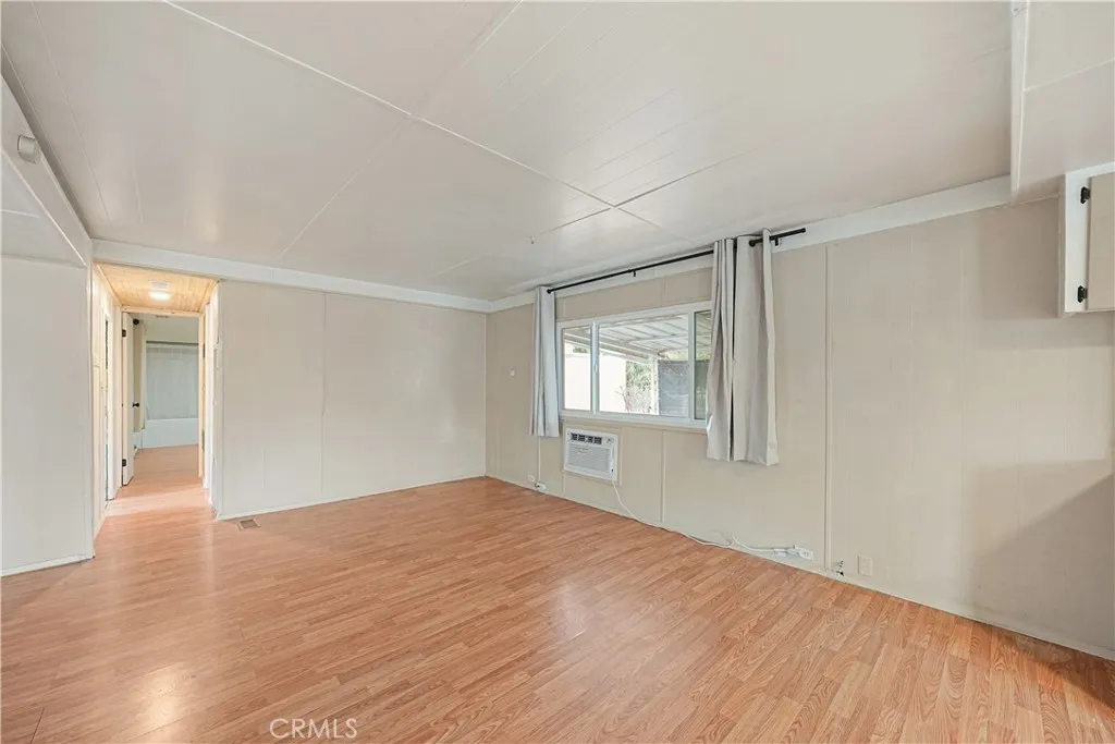 8787 Locust, Unit 24 Fontana, CA 92335 - Photo 12 of 27 a view of empty room with wooden floor and fan