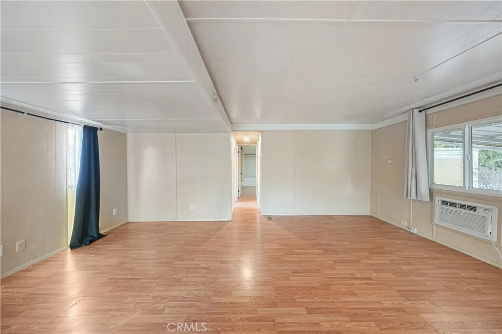 8787 Locust, Unit 24 Fontana, CA 92335 - Photo 13 of 27 a view of an empty room with window and wooden floor