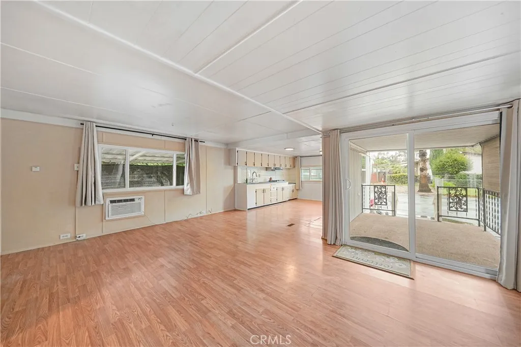 8787 Locust, Unit 24 Fontana, CA 92335 - Photo 14 of 27 a view of an empty room with a window and wooden floor