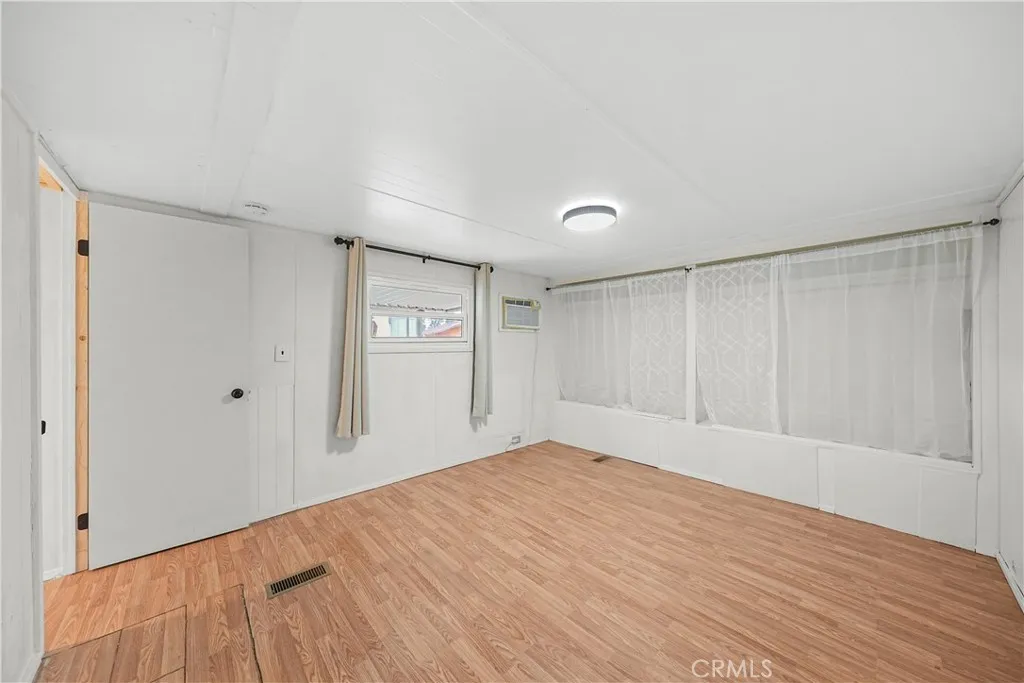 8787 Locust, Unit 24 Fontana, CA 92335 - Photo 23 of 27 a big room with wooden floor and natural light
