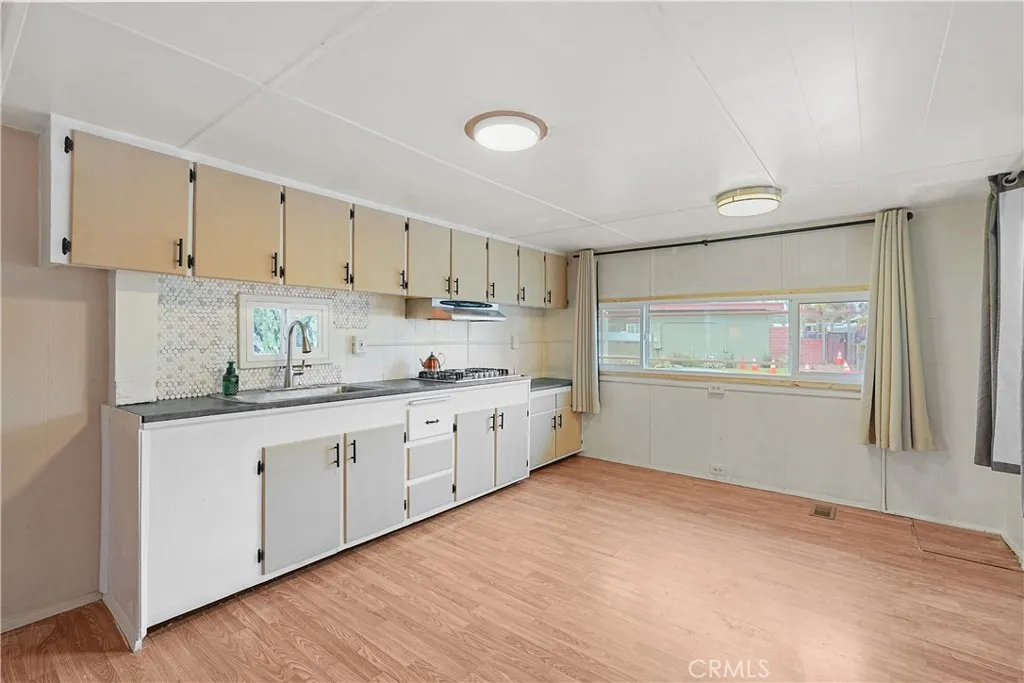 8787 Locust, Unit 24 Fontana, CA 92335 - Photo 7 of 27 a kitchen with granite countertop white cabinets and white appliances