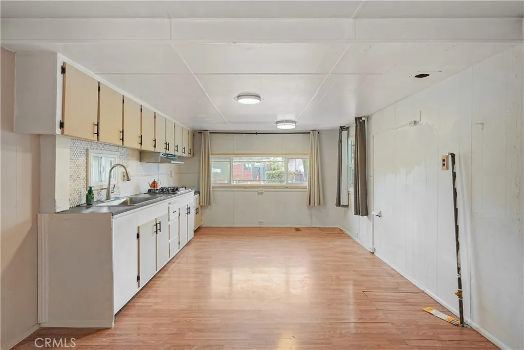 8787 Locust, Unit 24 Fontana, CA 92335 - Photo 8 of 27 a kitchen with granite countertop white cabinets and white appliances