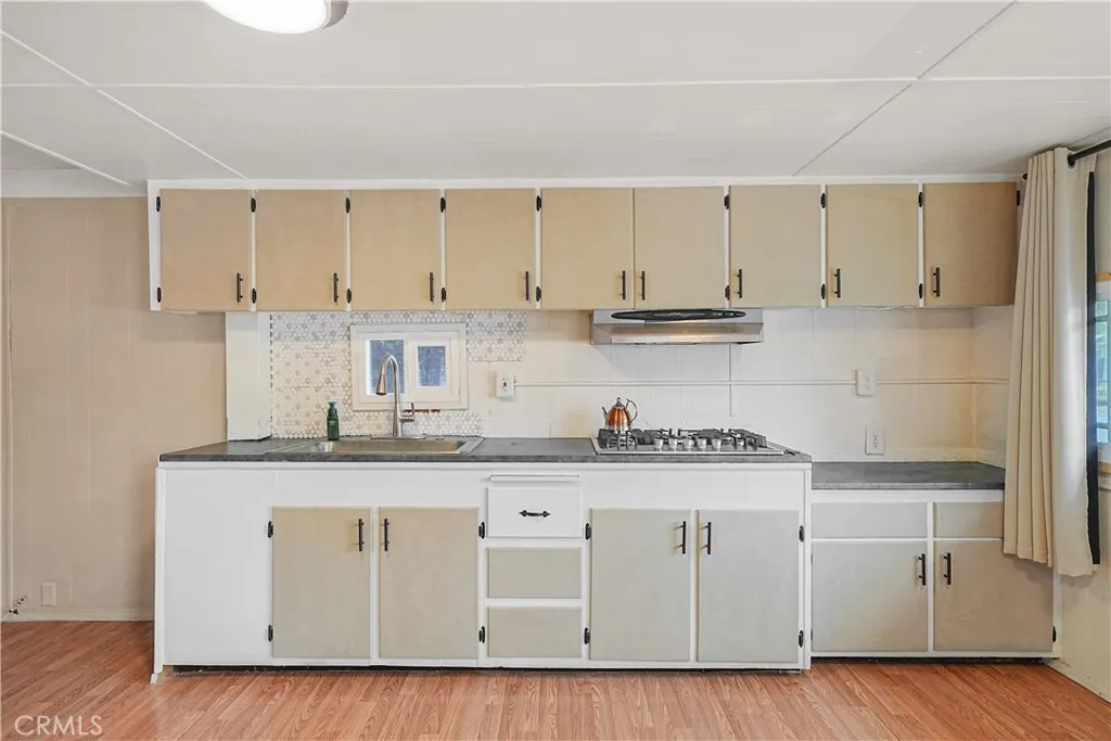 8787 Locust, Unit 24 Fontana, CA 92335 - Photo 9 of 27 a kitchen with granite countertop white cabinets and a sink