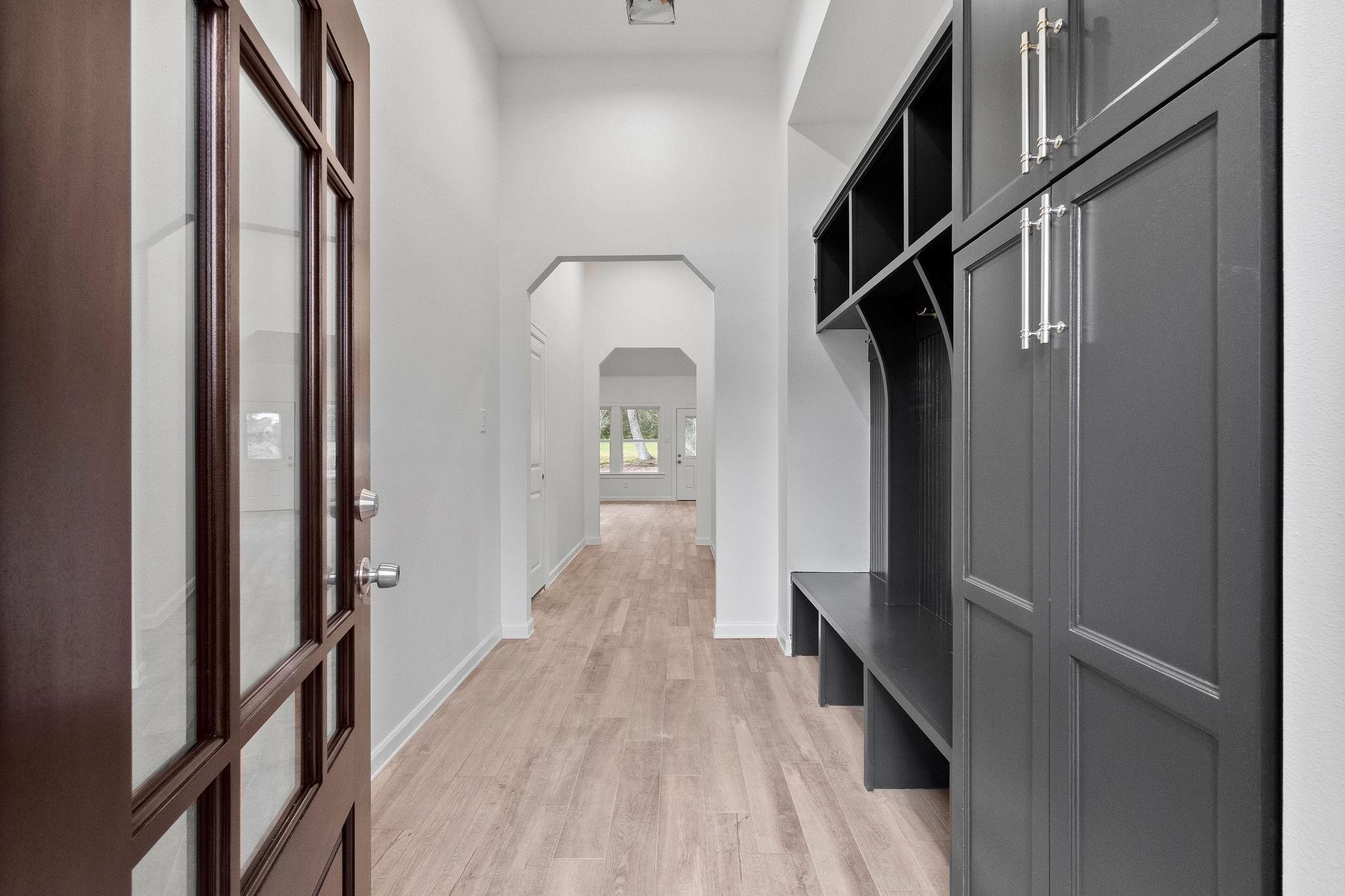 15479 Arrowhead Loop West Willis, TX 77378 - Photo 2 of 7 a view of a hallway with wooden floor and staircase