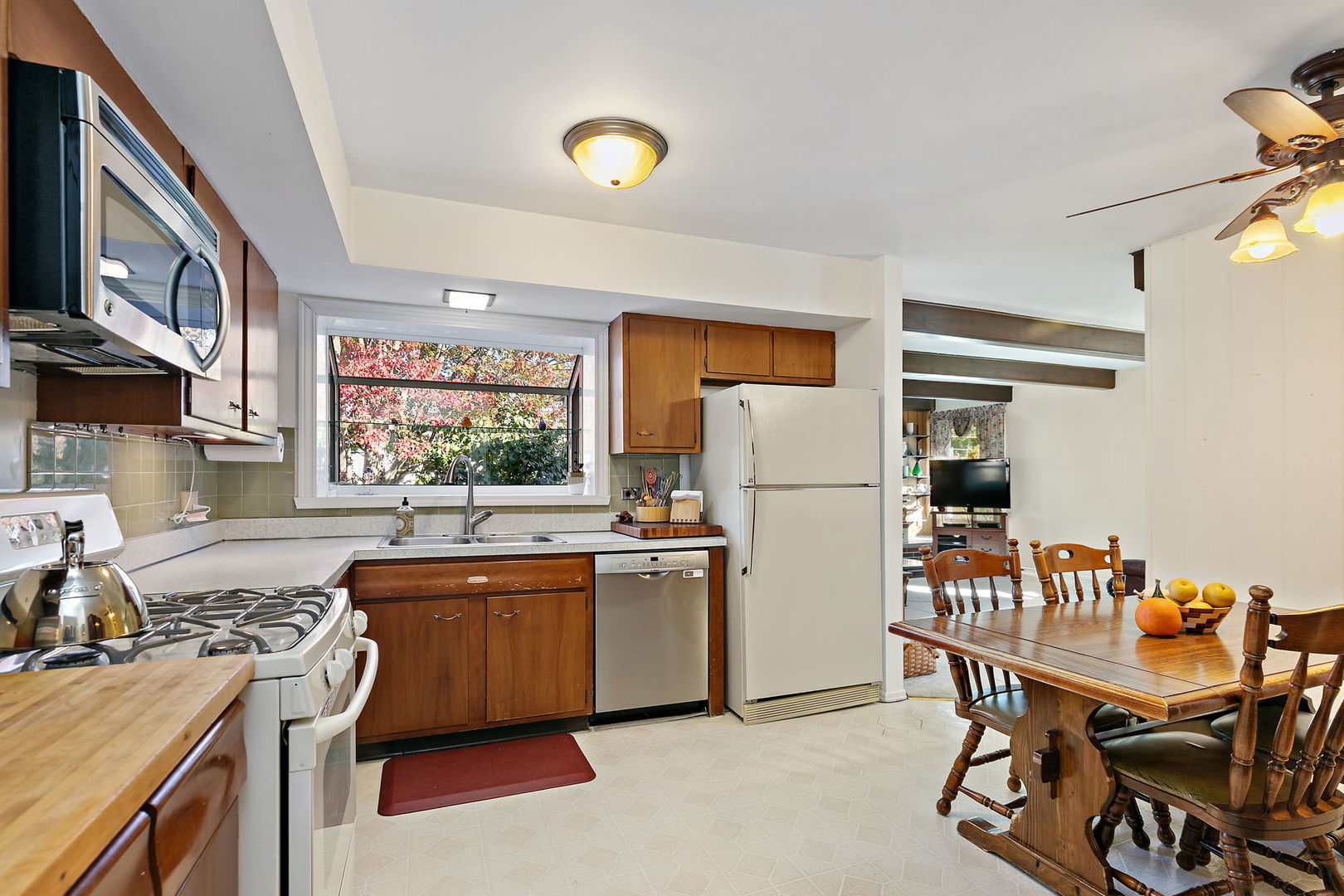 1410 Nottingham Lane Hoffman Estates, IL 60169 - Photo 12 of 29 a kitchen with stainless steel appliances granite countertop a sink stove and refrigerator