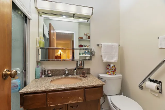 a view of a chairs and table in the back yard of the house