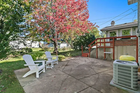 a view of a chair and table in the garden