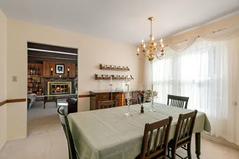 a view of a dining room with furniture and chandelier