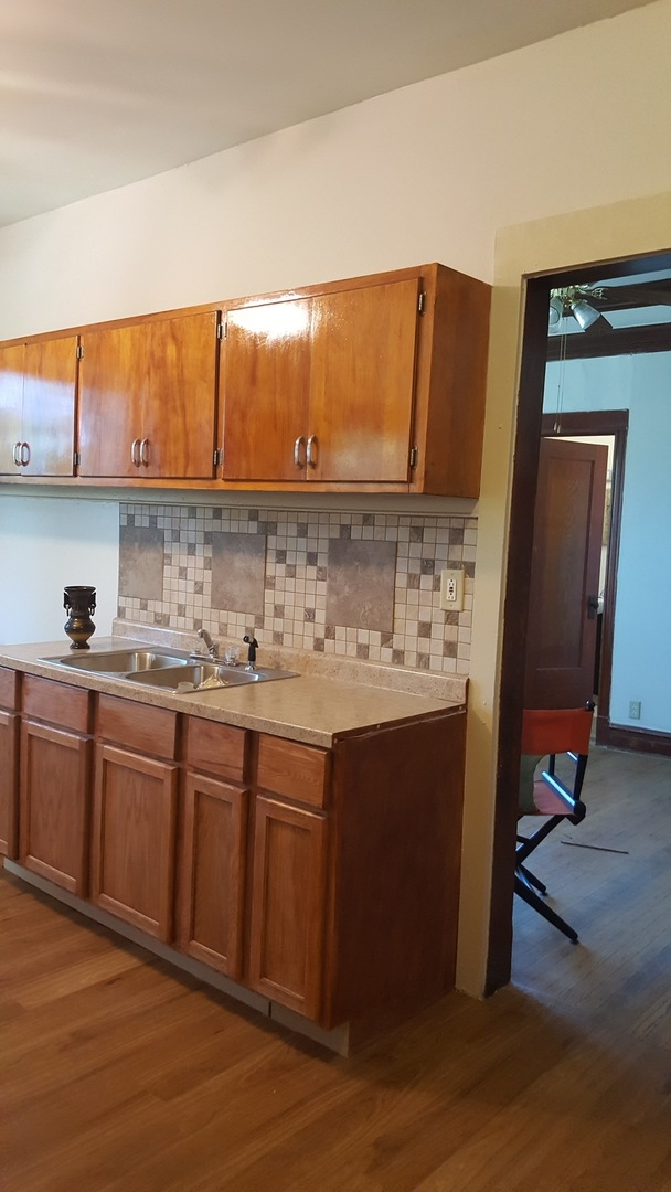 6844 South Normal Boulevard Chicago, IL 60621 - Photo 16 of 18 a kitchen with stainless steel appliances granite countertop a sink stove and cabinets