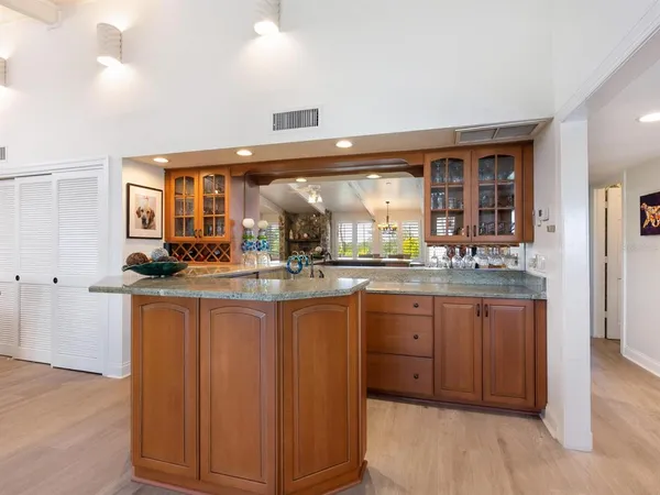 a kitchen with granite countertop a sink and cabinets
