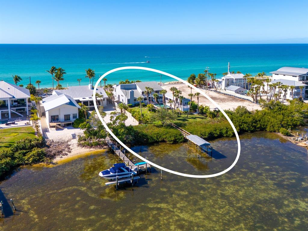 3240 Casey Key Road Nokomis, FL 34275 - Photo 2 of 51 a view of a swimming pool with an outdoor space and seating area