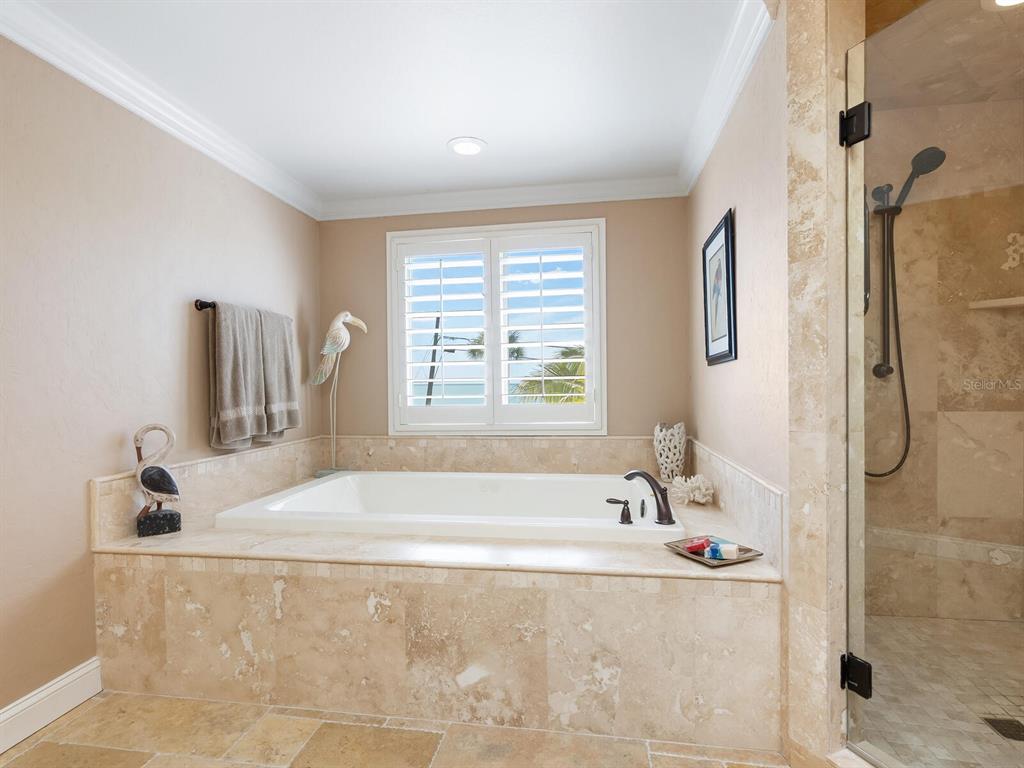 3240 Casey Key Road Nokomis, FL 34275 - Photo 23 of 51 a bathroom with a tub and a window