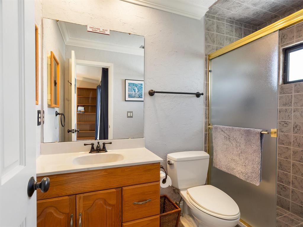 3240 Casey Key Road Nokomis, FL 34275 - Photo 26 of 51 a bathroom with a sink mirror vanity and a toilet