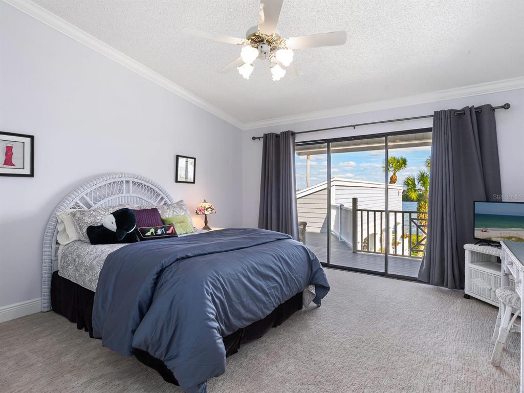 3240 Casey Key Road Nokomis, FL 34275 - Photo 27 of 51 a bedroom with a large bed and a tv