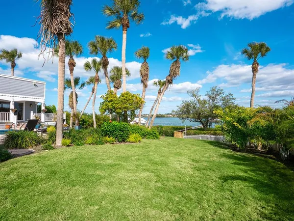 a front view of a house with swimming pool having outdoor seating