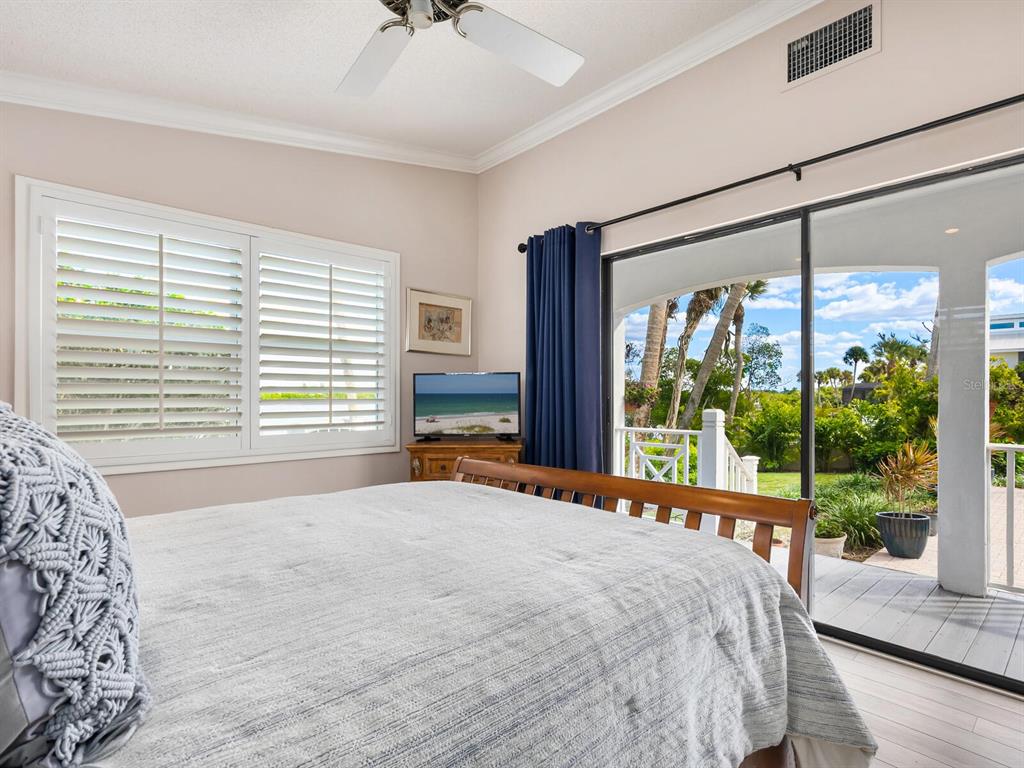 3240 Casey Key Road Nokomis, FL 34275 - Photo 40 of 51 a bedroom with a large bed and a large window