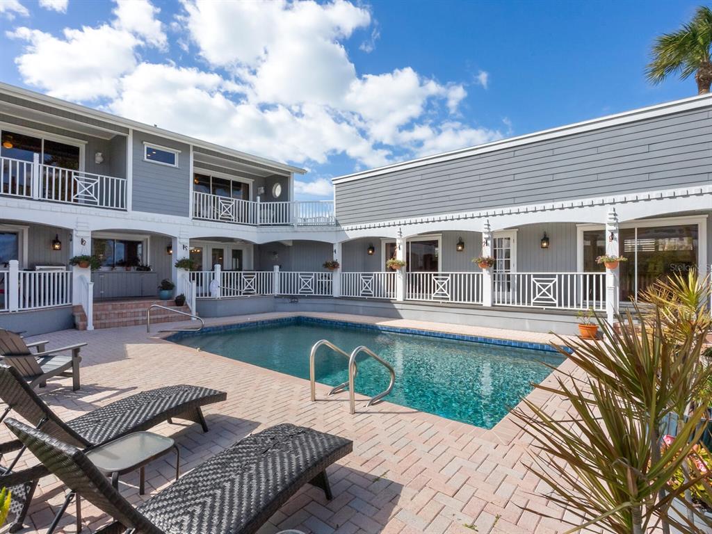 3240 Casey Key Road Nokomis, FL 34275 - Photo 43 of 51 a view of a house with swimming pool and sitting area