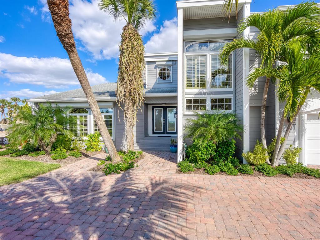 3240 Casey Key Road Nokomis, FL 34275 - Photo 5 of 51 a front view of a house with a yard and outdoor seating