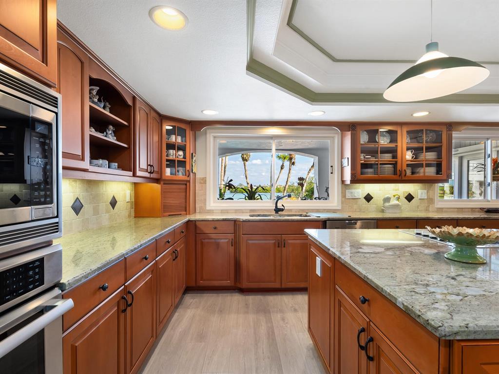 3240 Casey Key Road Nokomis, FL 34275 - Photo 9 of 51 a large kitchen with stainless steel appliances granite countertop a lot of counter space and a sink