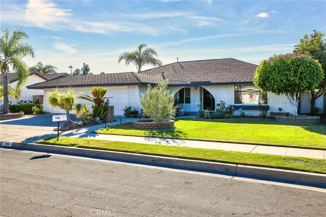 a view of a house with swimming pool and a yard