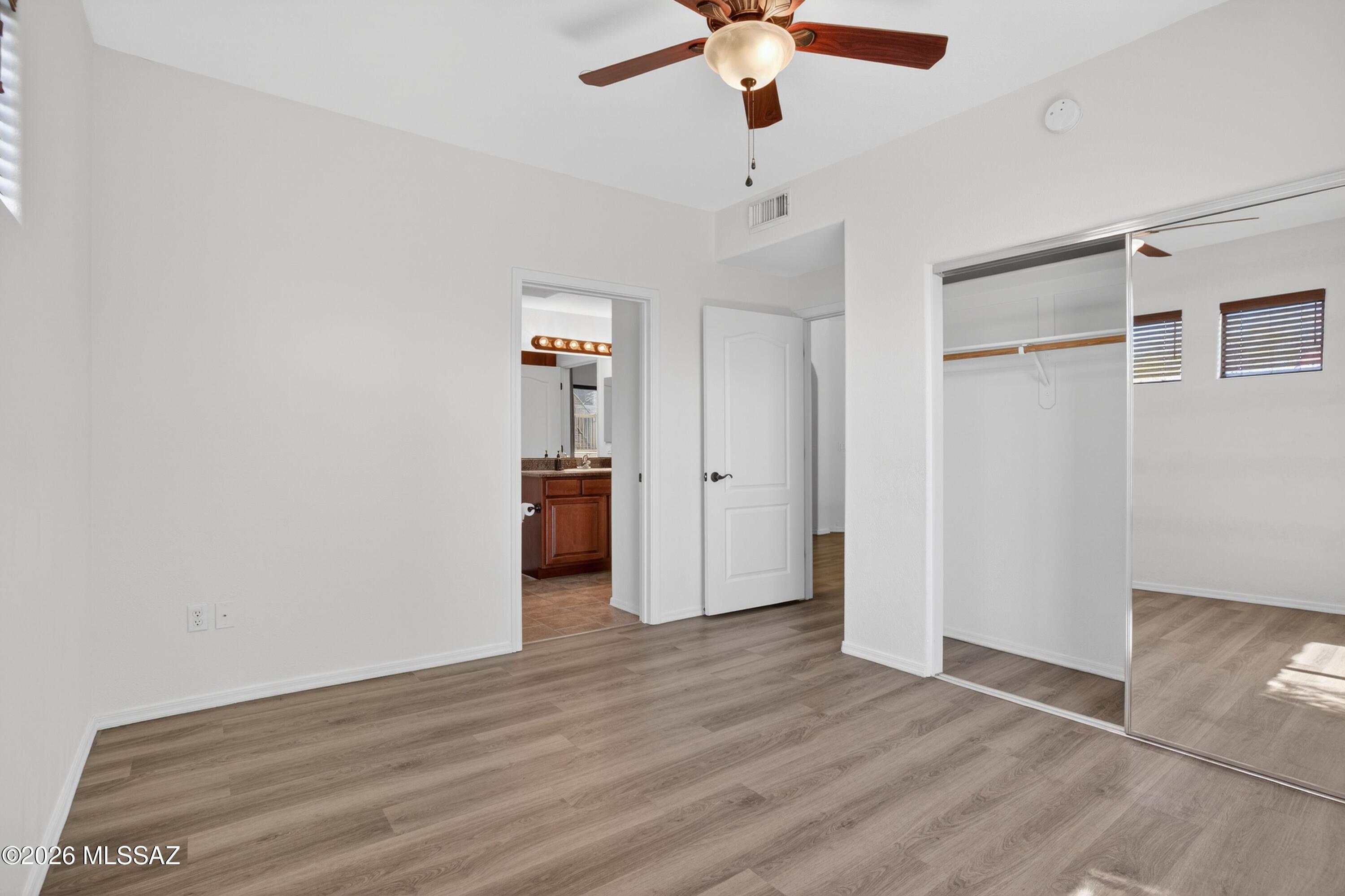 2550 East River Road, Unit 4204 Tucson, AZ 85718 - Photo 26 of 36 an empty room with wooden floor closet and windows