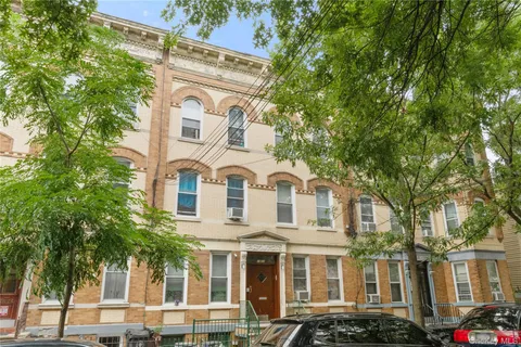 a front view of a residential apartment building with a yard
