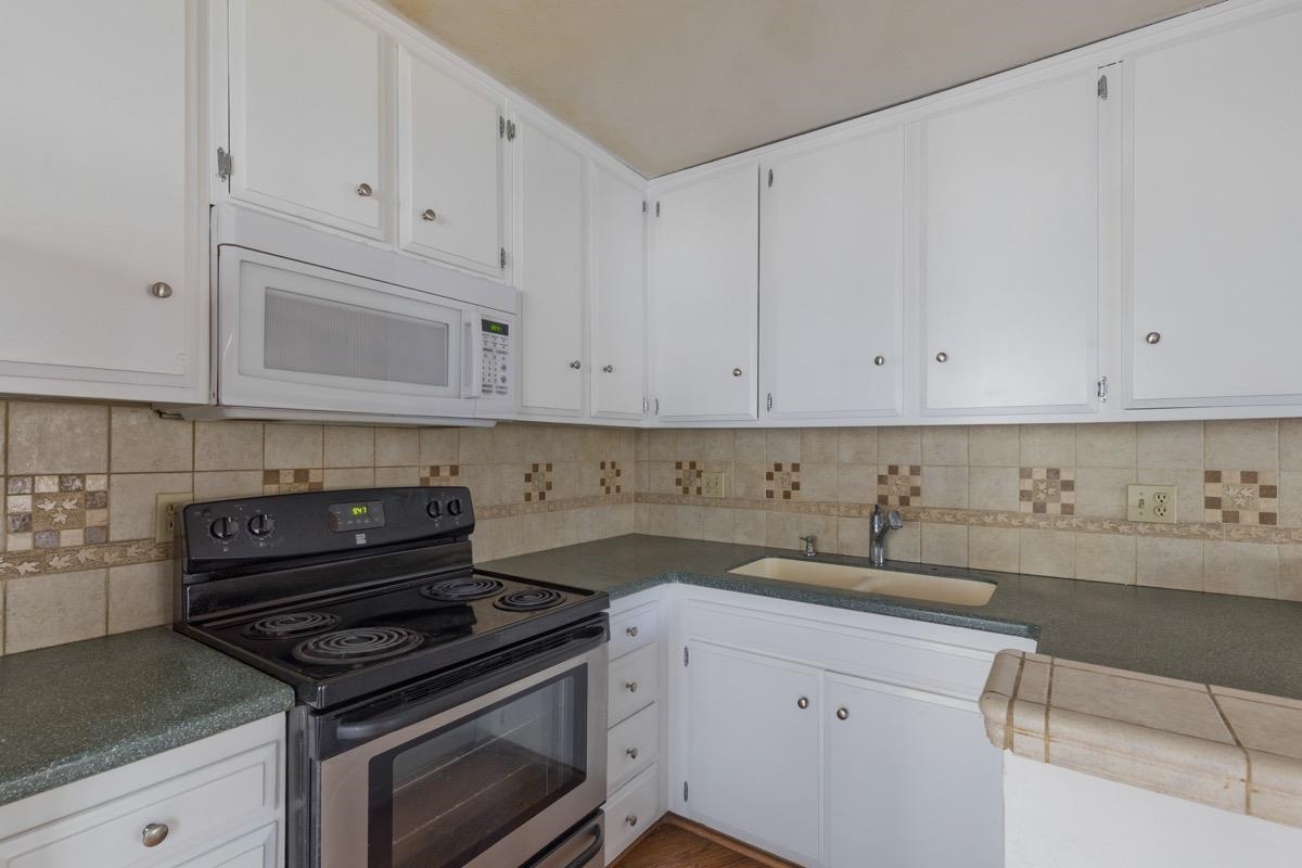 286 Old Mammoth Road, Unit 59 Mammoth Lakes, CA 93546 - Photo 8 of 31 a kitchen with white cabinets and appliances