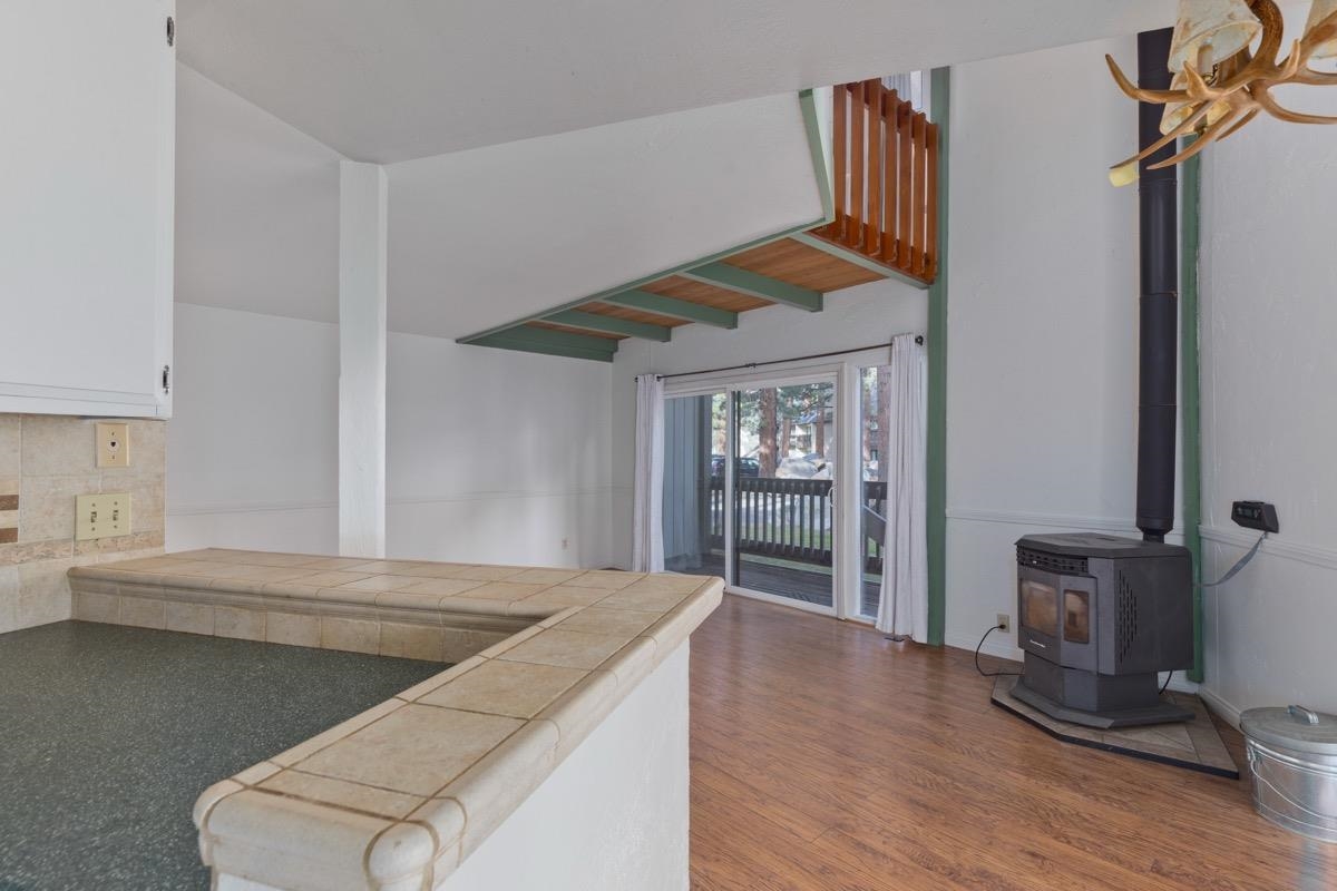 286 Old Mammoth Road, Unit 59 Mammoth Lakes, CA 93546 - Photo 9 of 31 a kitchen with kitchen island a stove a sink and a refrigerator with wooden floor