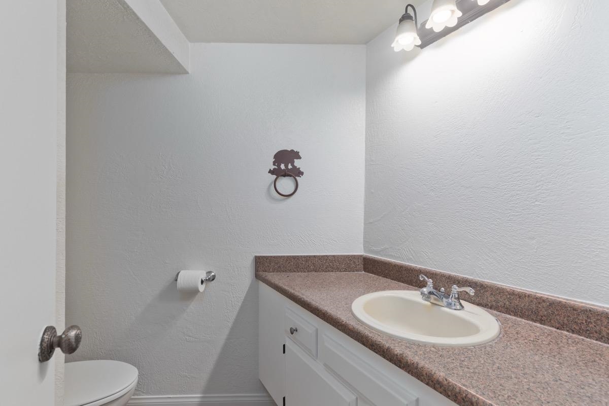 286 Old Mammoth Road, Unit 59 Mammoth Lakes, CA 93546 - Photo 10 of 31 a bathroom with a granite countertop sink and a mirror