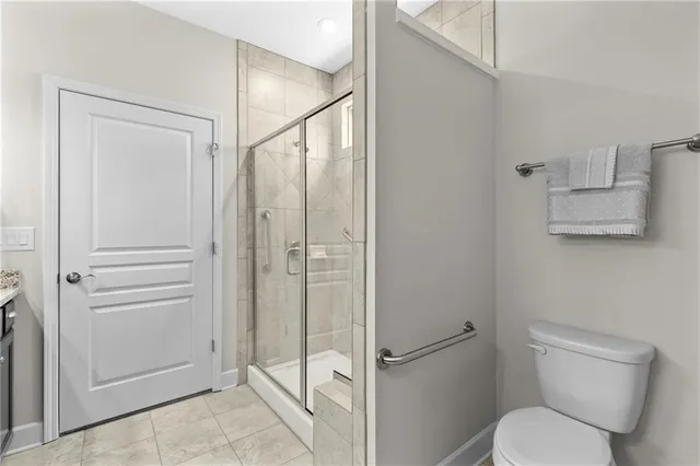 a bathroom with a toilet and a shower