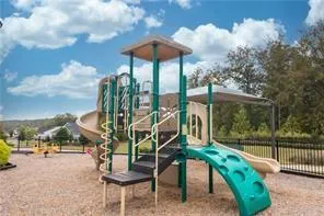 a view of a patio with a table chairs and a floor to ceiling window