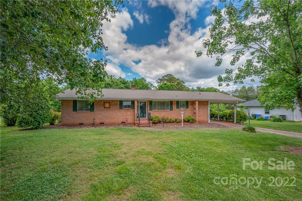 136 Crestview Street Rutherfordton, NC 28139 - Photo 2 of 34 a view of a house with a big yard and large trees