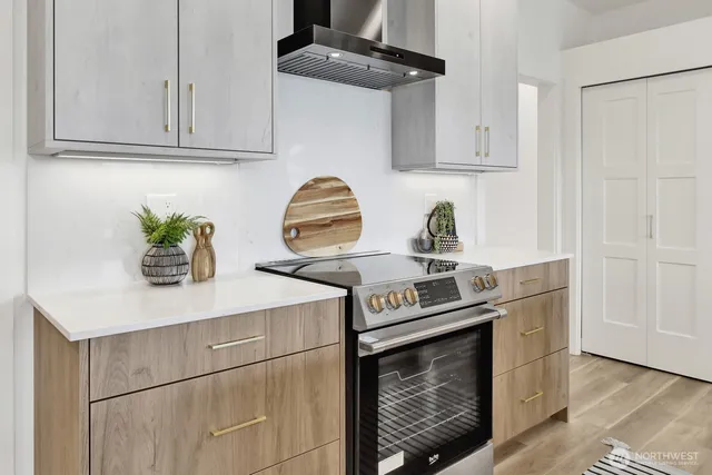 a kitchen with stainless steel appliances a sink a table and chair