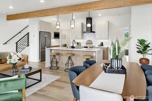 a living room with furniture kitchen view and a table