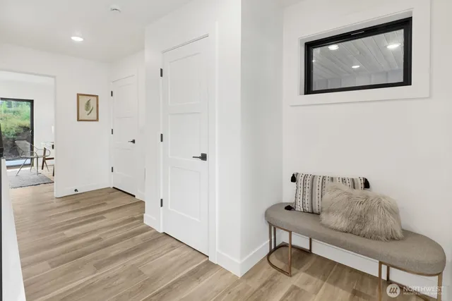 a hallway with wooden floor and furniture