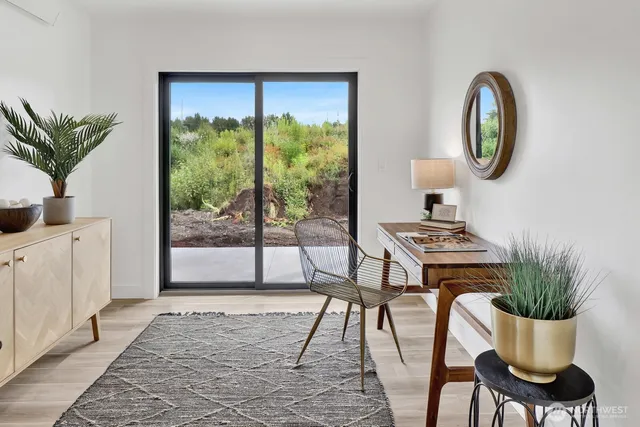 a dining room with furniture and a potted plant