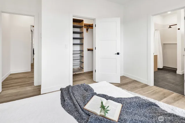 a bed sitting in a bedroom next to a window