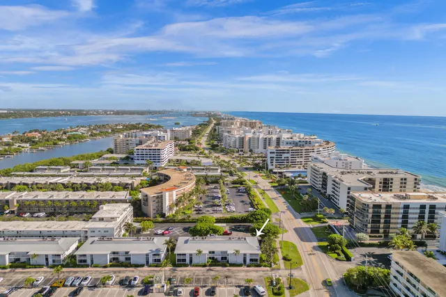 an aerial view of residential building and ocean view