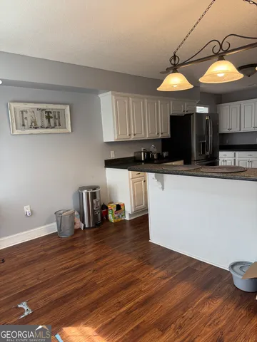 a kitchen with stainless steel appliances granite countertop a sink and cabinets