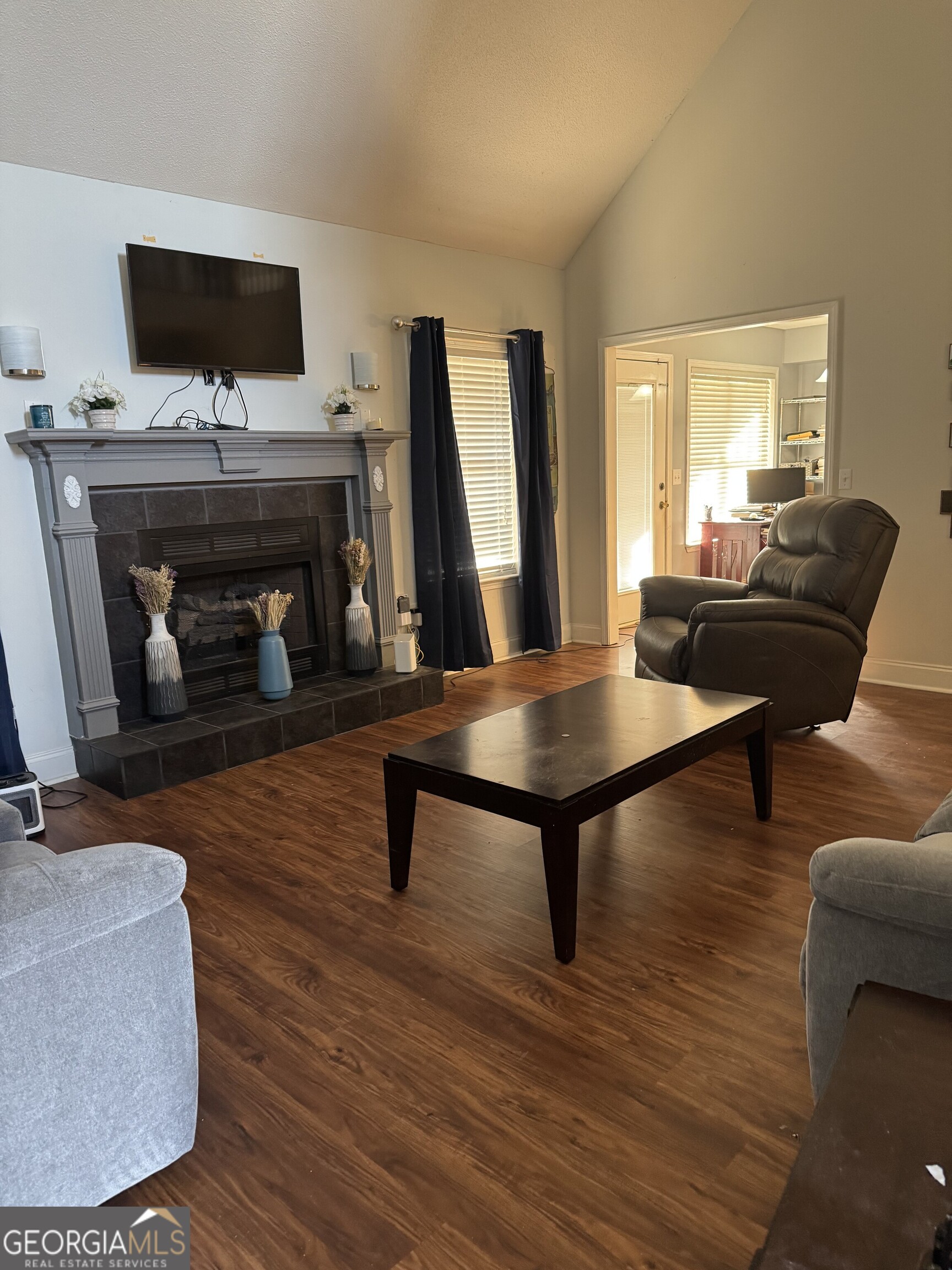 2132 Kings Chapel Road Perry, GA 31069 - Photo 5 of 13 a living room with furniture a fireplace and a flat screen tv