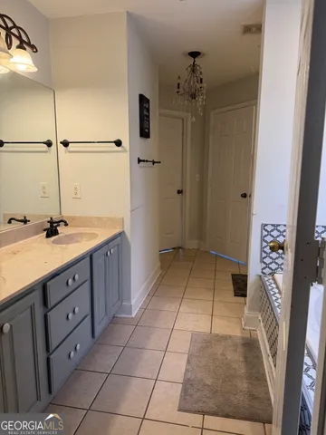 a spacious bathroom with a sink a mirror and a shower