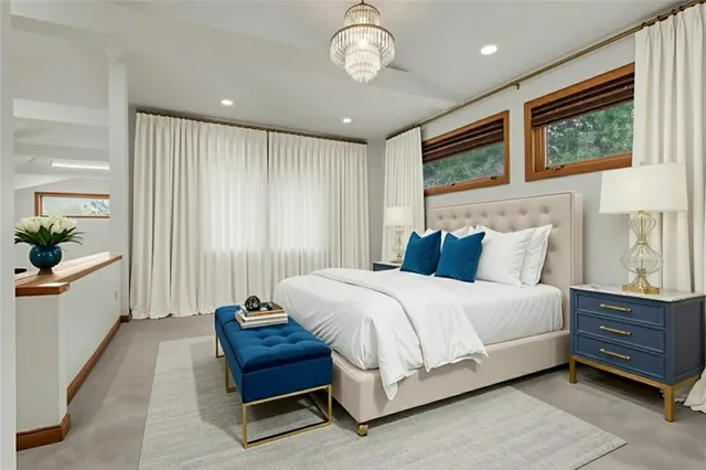 a spacious bedroom with a bed and a window