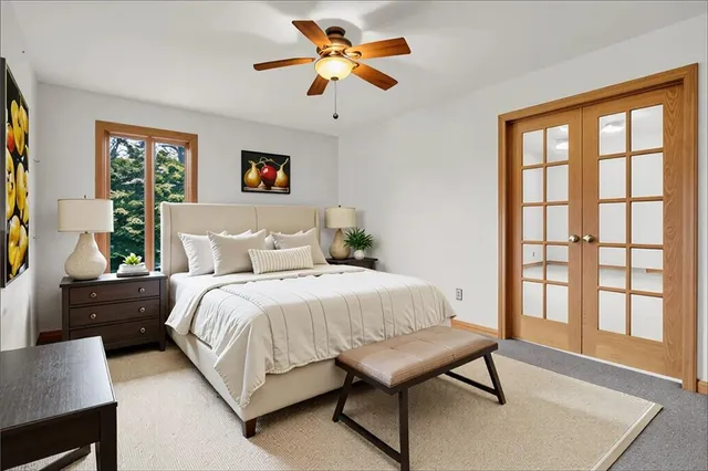 a bedroom with a bed and a window