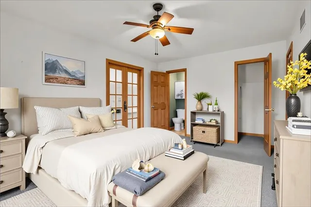 a bedroom with a bed and a chandelier