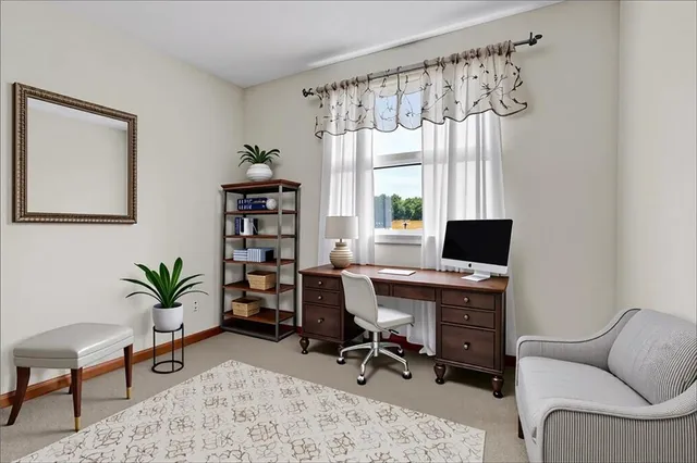 a view of a workspace with a window and chair in a room