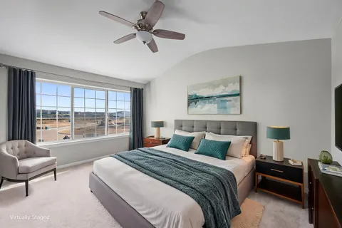 a bedroom with a large bed and a large window