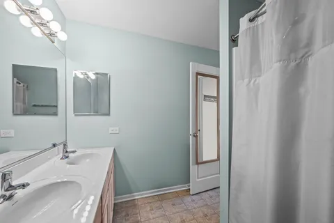 a bathroom with a sink vanity and mirror